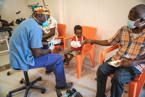 Osmé, 3, was injured when a 7.2 magnitude earthquake hit southern Haiti in 2021. ​ He was brought to MSF's Tabarre trauma hospital in Port-au-Prince for treatment. Here staff encourage him to play to help rehabilitate his arm.