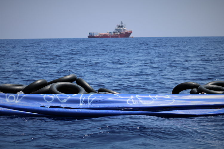 An empty rubber boat after all on board have been rescued. The SOS Mediterranee team mark the rubber boat to show those on board have been rescued. Ocean Viking in the background.

On August 11, Ocean Viking conducted its third rescue in the Central Mediterranean Sea, rescuing 81 people from an unseaworthy rubber boat. 
Copyright: MSF/Hannah Wallace Bowman