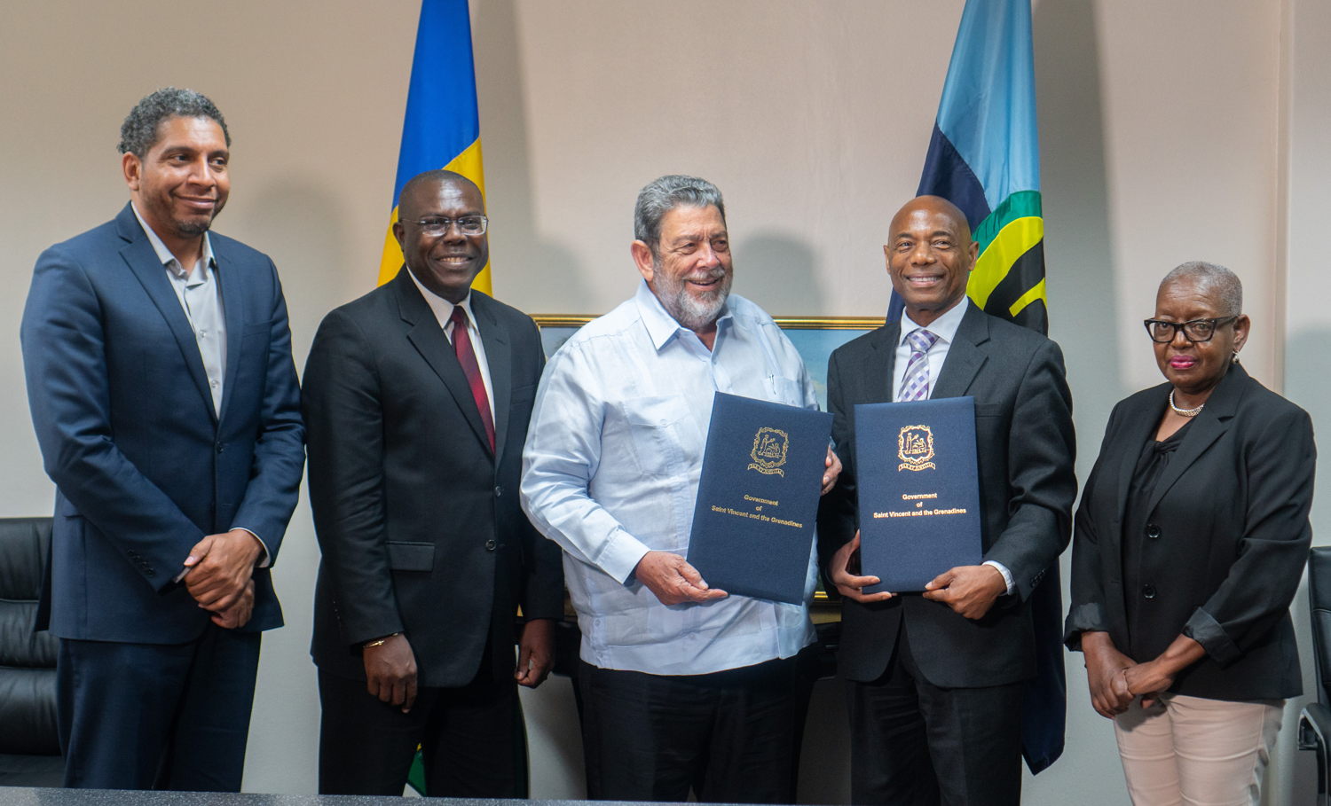 President of the Caribbean Development Bank (CDB) Dr. Gene Leon (second right) and Prime Minister of St. Vincent and the Grenadines (SVG) Dr. Ralph Gonsalves, (centre) display symbolic agreement instruments after CDB announced an Immediate Response Loan of US$5 mn and an Emergency Assistance Grant of US$300,000 to support the response to the La Soufriere volcanic eruption. The support package was announced at a press conference which was held at the Office of the Prime Minister in Kingstown. On hand for the announcement were Minister of Finance, Economic Planning and Information Technology, Camilo Gonsalves, (far left) who serves as CDB Governor for SVG, CDB’s Vice President, Operations, Isaac Solomon (second left) and Dorla Humes, Advisor to the CDB President. The CDB team are on an official visit to SVG which is scheduled to run until Sunday July 25, 2021.