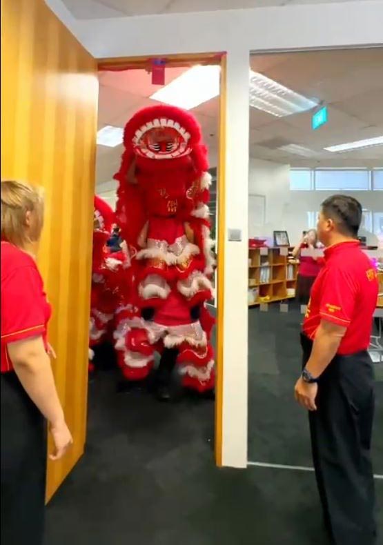 The lions attempting to grab the Ang Pao hanging from our CEO Lim Siew Tin's office door frame