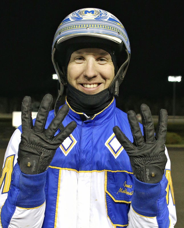 James MacDonald holds up eight fingers after winning a single-night record eight races. (New Image Media)