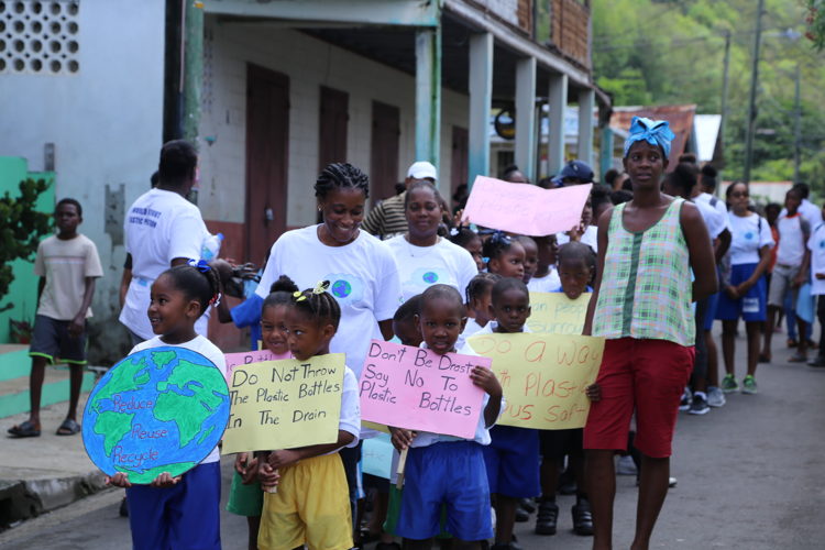 Students marching in the streets of Anse-La-Raye before the start of the clean up activity