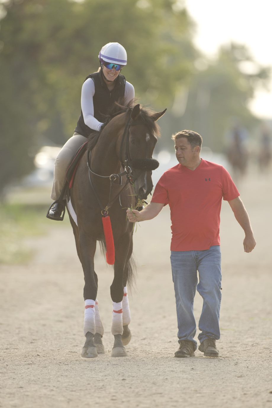 Moira and exercise rider Korina McLean head to the track on Thursday morning with trainer Kevin Attard. (Michael Burns photo)