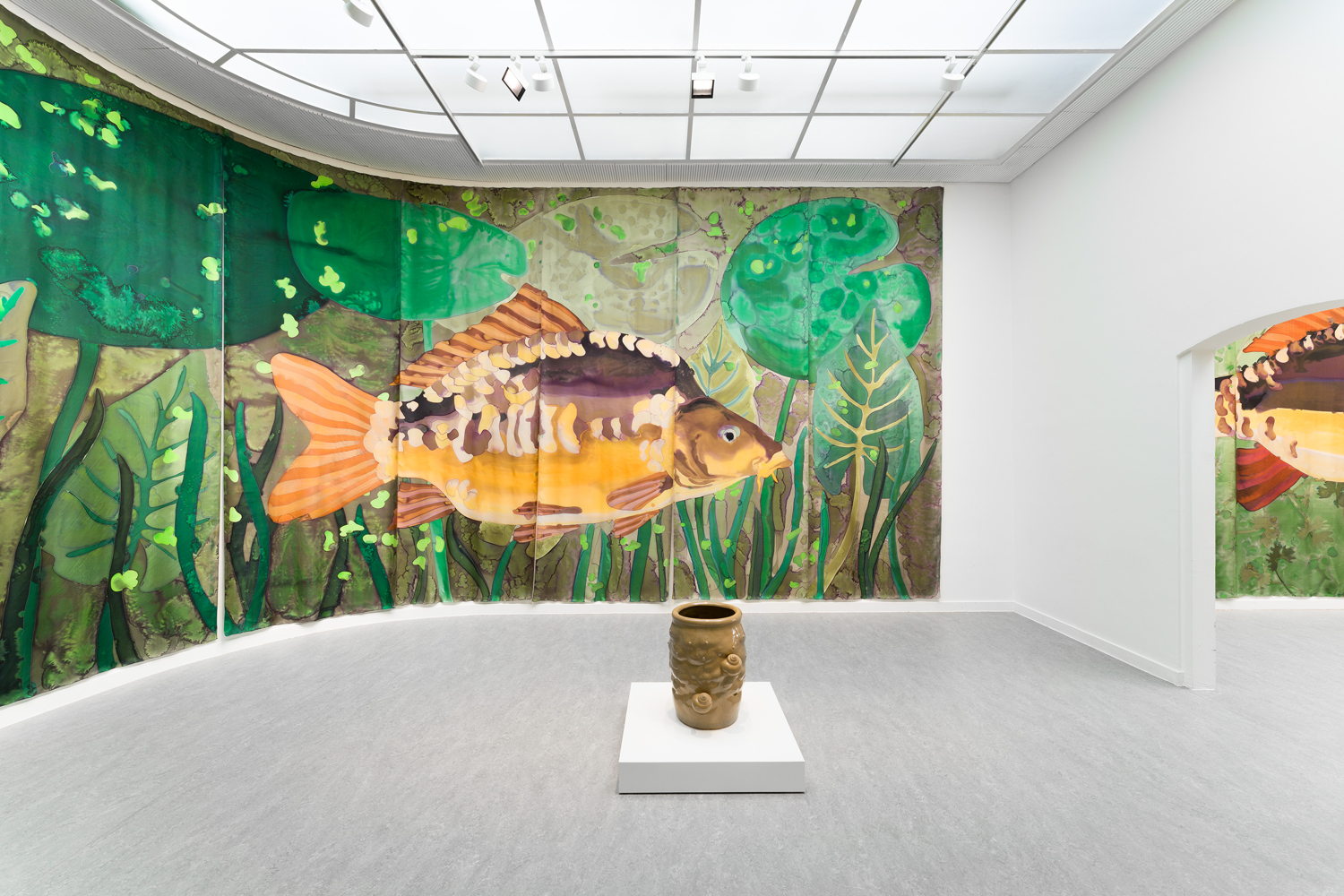 Daniel Dewar & Grégory Gicquel, Installation view The Wet Wing at Z33, Hasselt. Foreground: Stoneware jar with body fragments and snails, 2022. Background: Silk painting with mirror carp, water lilies and duckweed, 2025. Commissioned by Z33. Courtesy the artists. Photo: Lola Pertsowsky