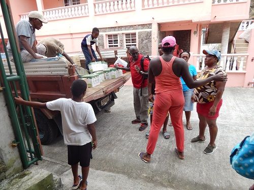 Grenada's Ambassador to the OECS H.E Dr. Patrick Antoine helps distribute relief in Grenada 

Photo credit: Janeka Simon