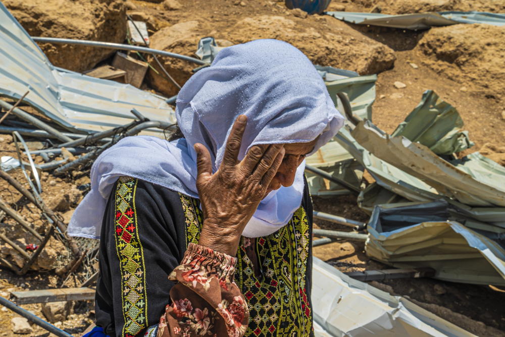 Safa, a resident of Al- Markez gathering, Masafer Yatta. She says: " We were here when the demolition happened. My daughters were here and the little kids. This happened for the first time in December [2021]. Then they came again in May [2022]. They demolished the house, twice in a short period of time [after rebuilding in-between]. They came to demolish some shelters here a month ago, at the beginning of July. They come suddenly. They do not give notice. We only see the bulldozers coming to our place. and they demolish the tents." Copyright : Juan Carlos Tomasi/MSF