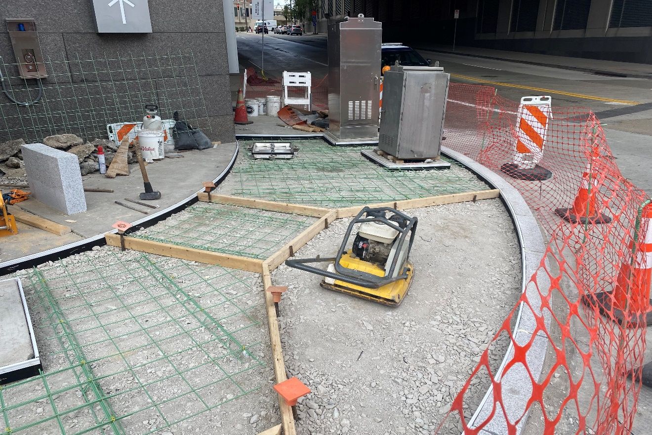 Wood frames were recently placed to form the new sidewalk and accessible ramps at Fifth and Sixth avenues