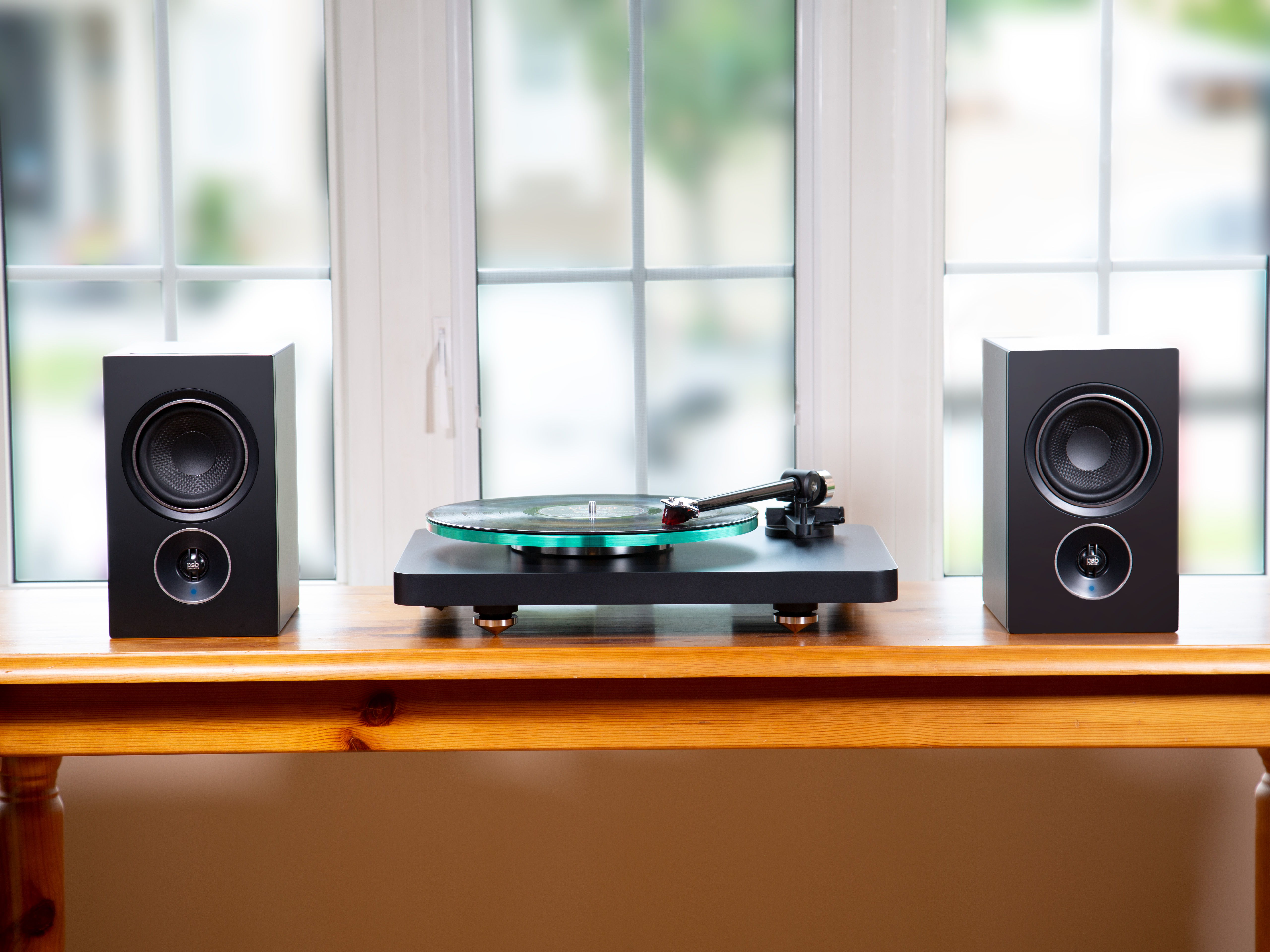 The Alpha iQ's between a turntable