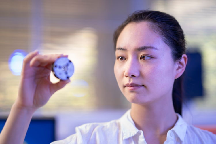 ANU PhD scholar Xingshuo Huang holds the diamond anvil that the team used to make the diamonds in the lab. Credit: Jamie Kidston, ANU