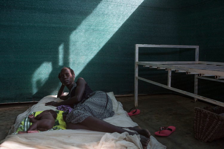 Nyakuech Mach, 30 lies on a bed in the prenatal ward of the Kule health center in the Kule refugee camp in the Gambella region of Ethiopia on 25 Oct 2017. She gave birth to a boy, Doctor Nyak, premature, 7 days earlier. Photographer: ZACHARIAS ABUBEKER Nyakuech Mach, 30 lies on a bed in the prenatal ward of the Kule health center in the Kule refugee camp in the Gambella region of Ethiopia on 25 Oct 2017. She gave birth to a boy, Doctor Nyak, premature, 7 days earlier. Photographer: ZACHARIAS ABUBEKER