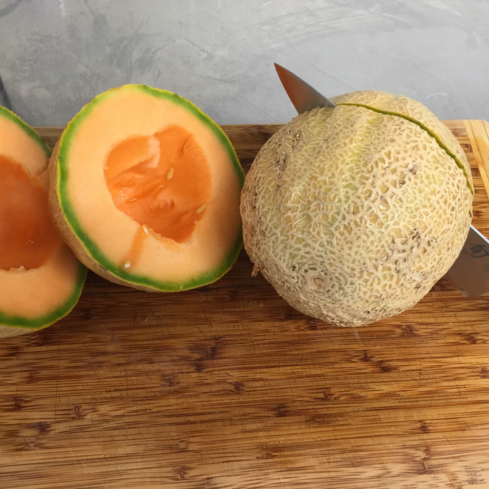 Slicing organic Hirakata Farms cantaloupe before adding it to the wort