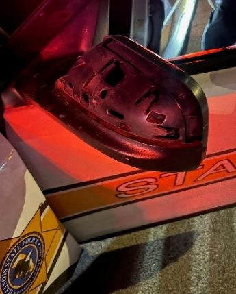 Driver’s side mirror of damaged Troop 4 squad car