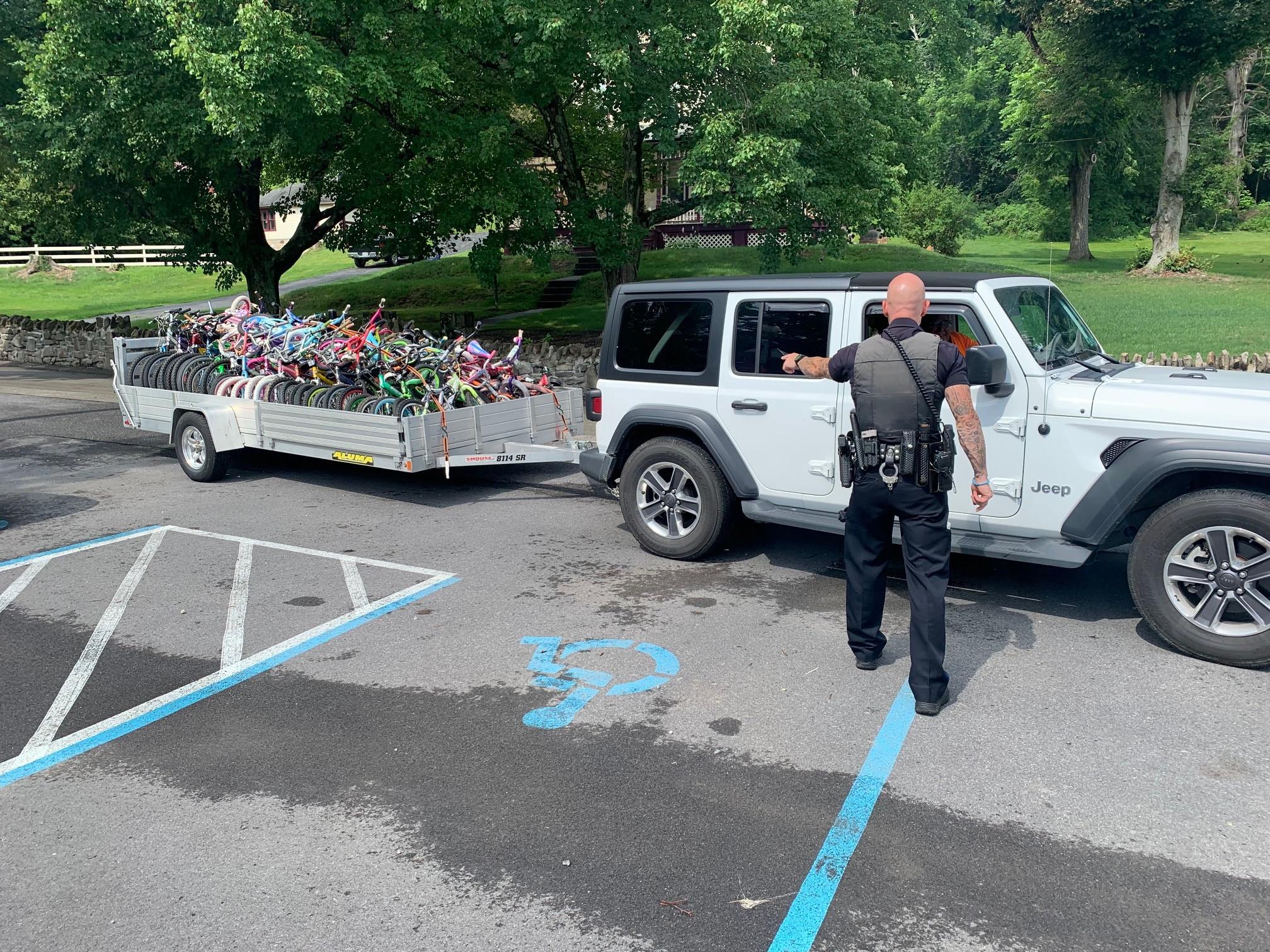 Johnstown police welcome a trailer full of bicycles to be given away to children at Roxbury Park on Jul. 17, 2021 in Johnstown, Pa.