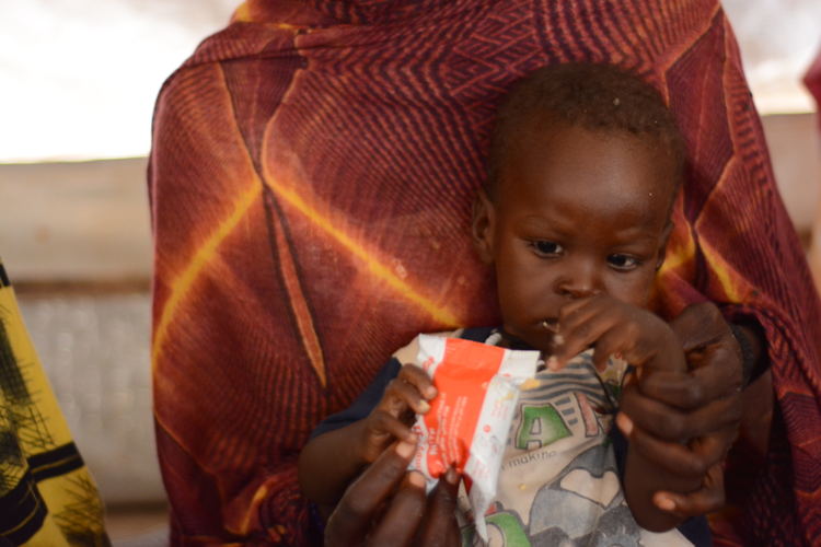 Alam Aldeen, 2.5 years old, sits on his mother Hawa’s lap in the ATFC at Zamzam Camp, North Darfur, suffering from severe malnutrition and awaiting treatment. Zamzam camp near El-Fasher | 30/08/2024 | Photographer: Mohammed Jamal.