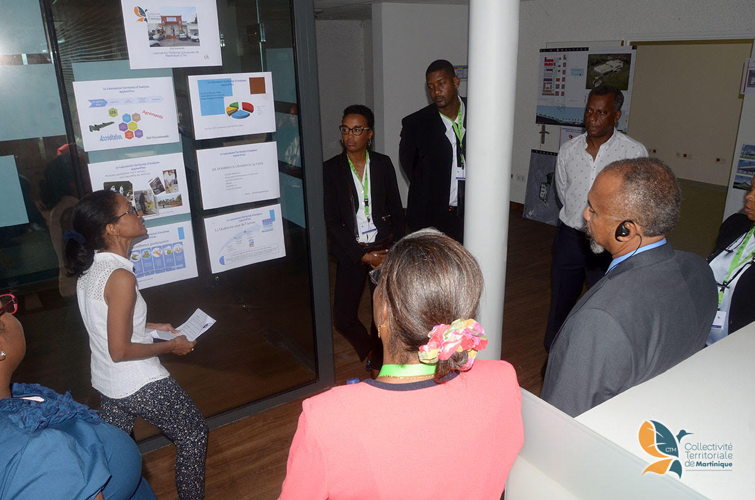 Delegation members review health progress statistics.