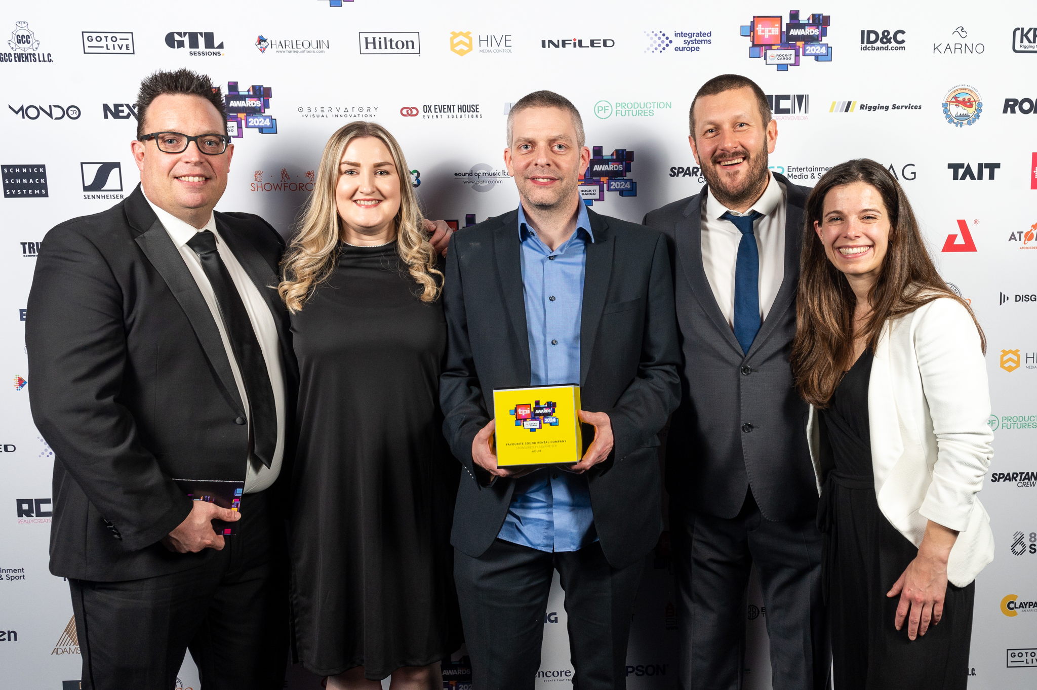 Sennheiser proudly sponsored the 'Favourite Sound Rental Company' category at TPi Awards, which was won by Adlib Audio
Picture from left to right: Kevin Gwyther-Brown – Business Development Manager, Sennheiser, Leah Coyle – Account Handler, Adlib, Dave Jones – Director, Adlib, Richy Nicholson – Senior Account Manager, Adlib, Theresa Vondran, Category Market Manager, Sennheiser