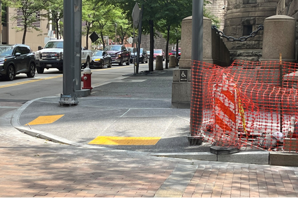 New sidewalk with granite curb and accessible ramps recently placed at Fifth Avenue and Grant Street