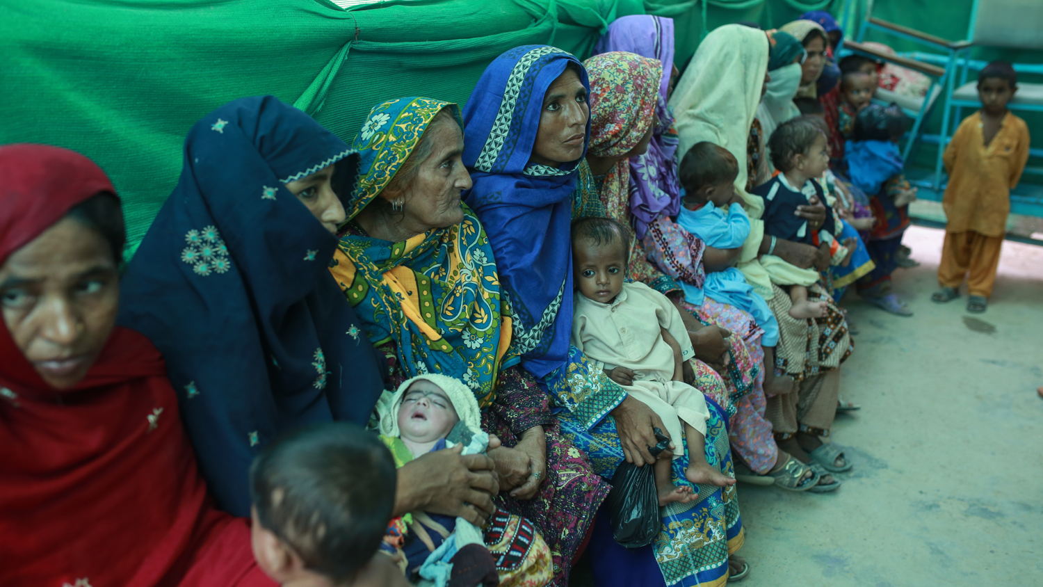 Mothers with their babies wait outside the ambulatory therapeutic feeding centre
(ATFC) run by MSF at the DHQ hospital, Dera Murad Jamali in Balochistan province,
Pakistan. Photographer: Sara Farid