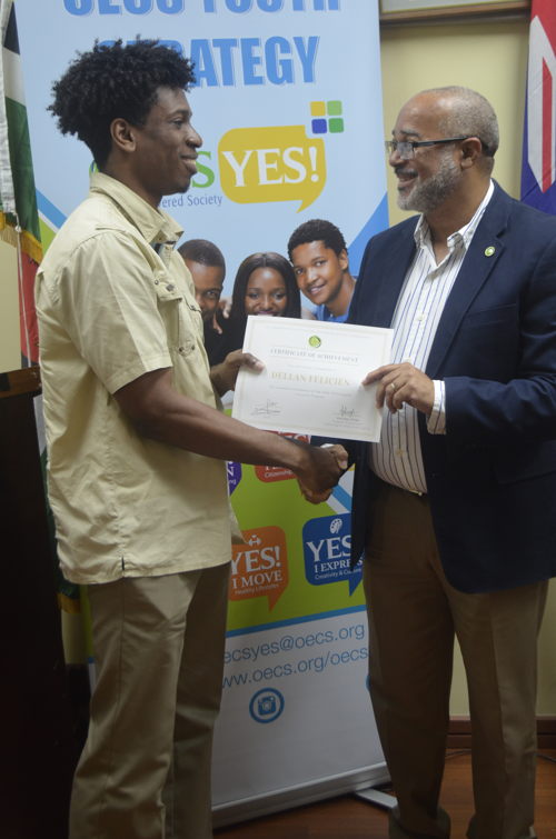 Dr. Jules presents certificate to graduate