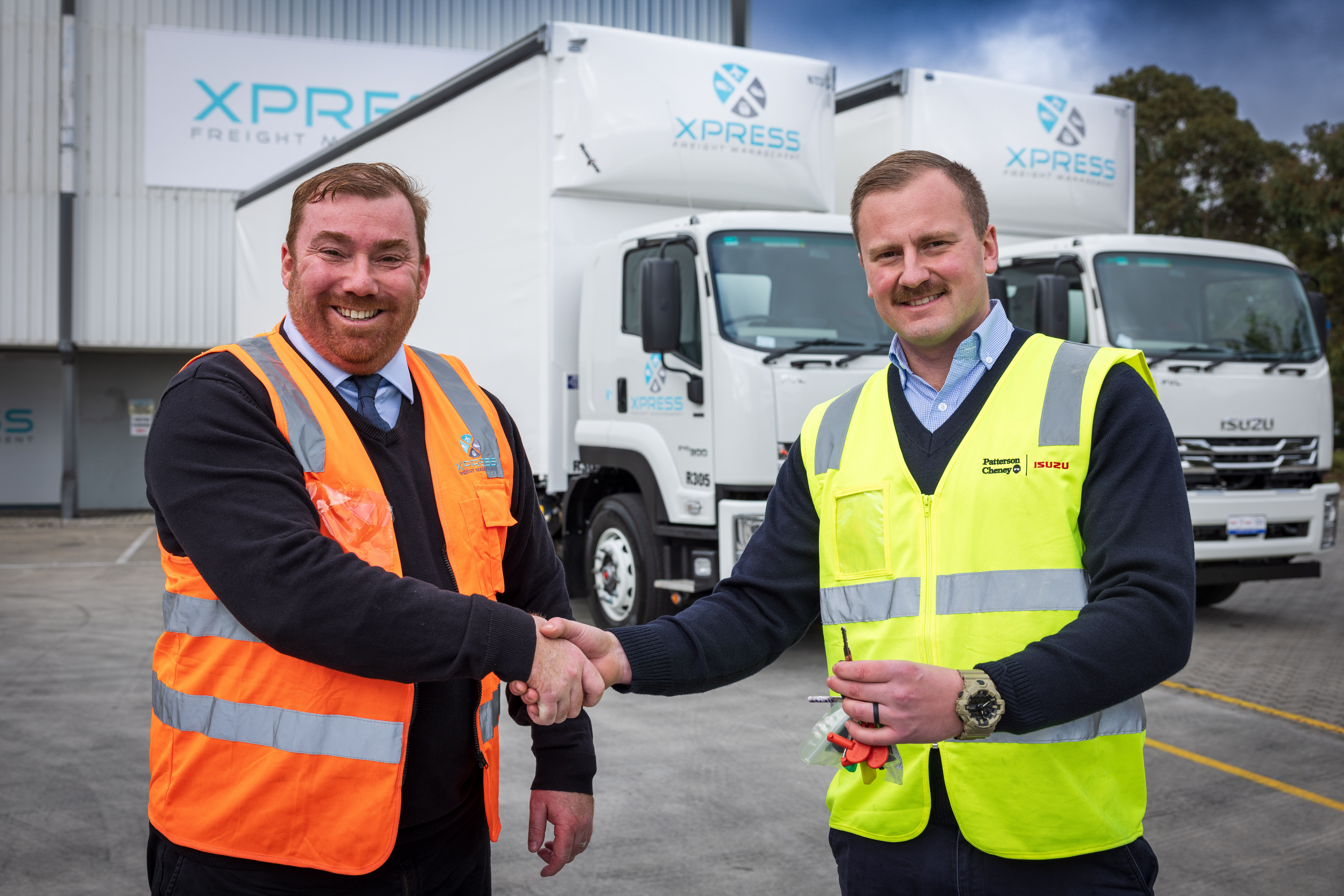 XFM Managing Director Les Sharp (left) gets the keys to a new Isuzu from Patterson Cheney Sales Supervisor Jordan Stannus