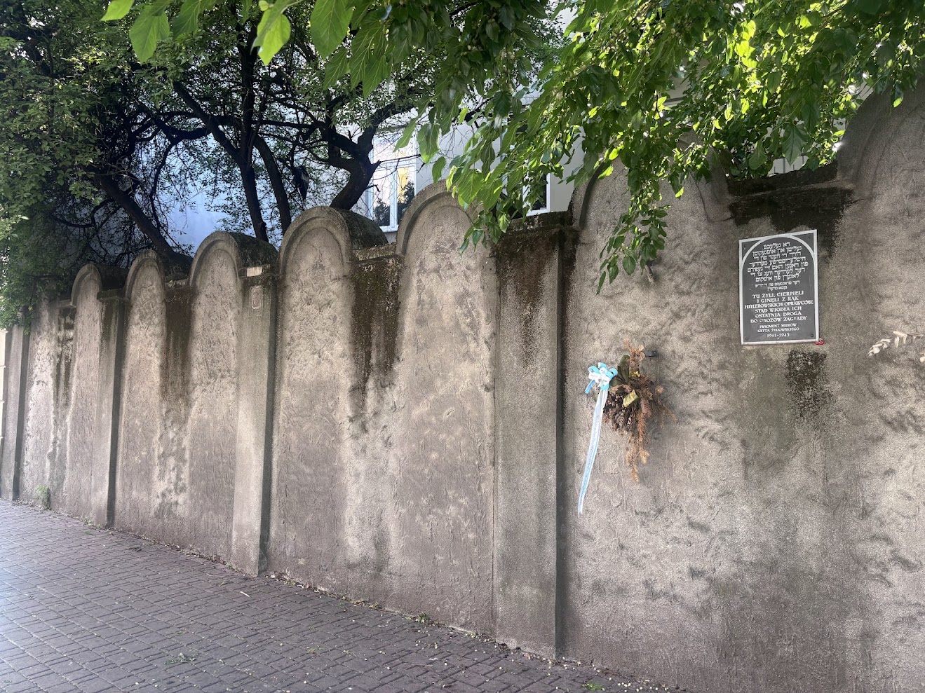 Remnant of the stone wall built around Krakow ghetto in 1941, marked with a memorial plaque.