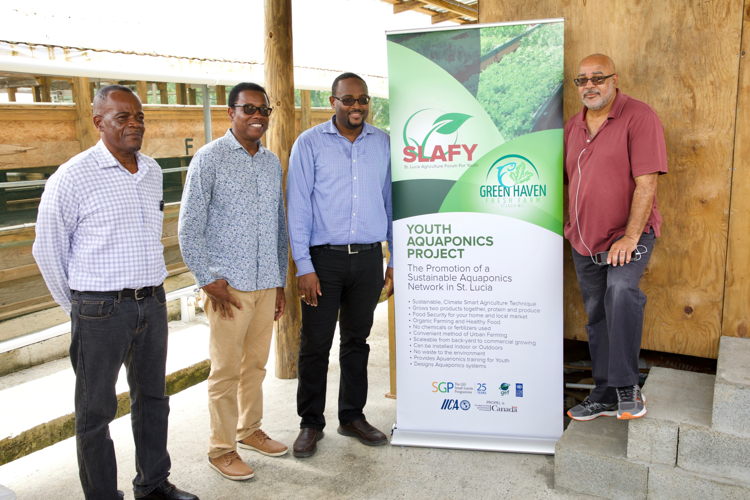 OECS Director General Dr. Didacus Jules (right) with Minister Jonas and delegates supporting aquaponics growth in the OECS