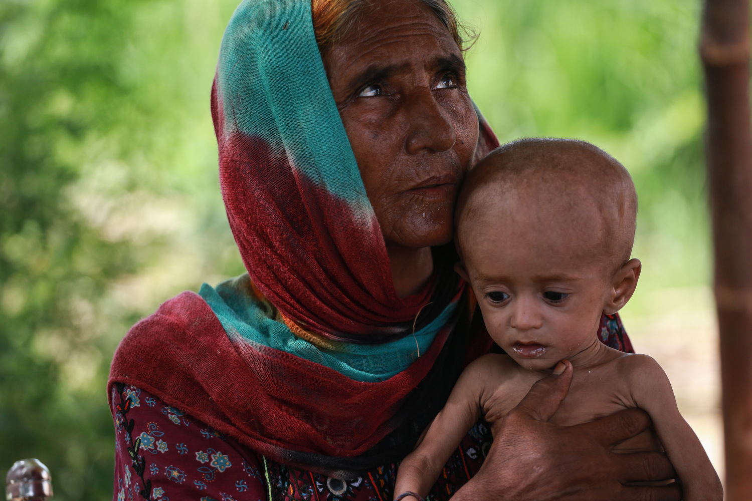 1 year old Yasin sits in his grandmother's lap at the mobile clinic set up at Sikandarabad, district Naseerabad in Balochistan province, Pakistan. Photoghrapher: Sara Farid