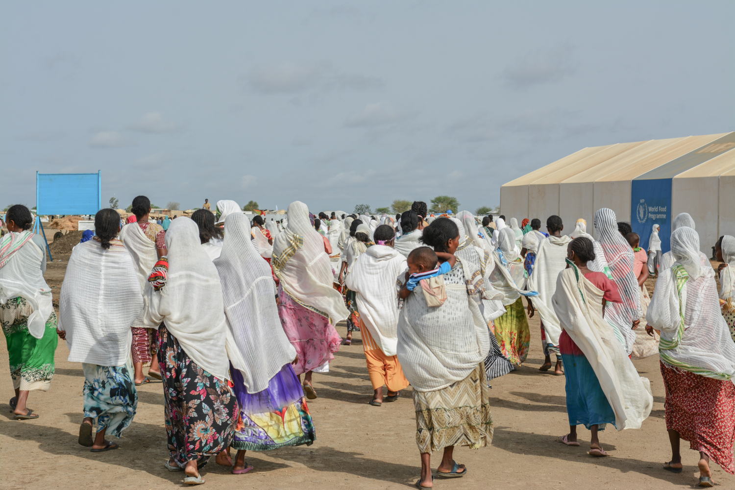 Women walk behind the coffin of a woman being taken for burial in Al Tanideba camp. MSF has been treating a growing number of hepatitis e cases in the camp, as well as in Umm Rakouba and Al Hashaba/Village 8 transit camp. 