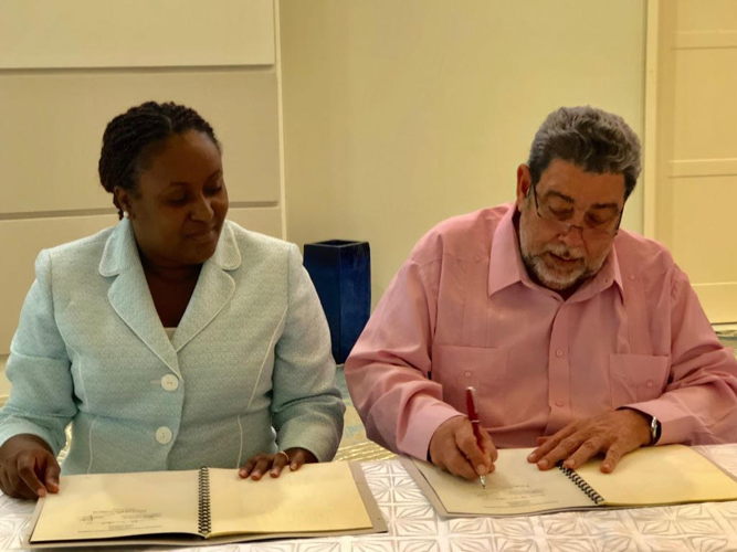 Incoming Chairman of the OECS Authority, Dr. Hon. Ralph Gonsalves, and Internal Auditor for the OECS Commission, Mrs. Mauricia Carr, sign Terms Of Reference for the OECS Audit Committee. Incoming Chairman of the OECS Authority, Dr. Hon. Ralph Gonsalves, and Internal Auditor for the OECS Commission, Mrs. Mauricia Carr, sign Terms Of Reference for the OECS Audit Committee.