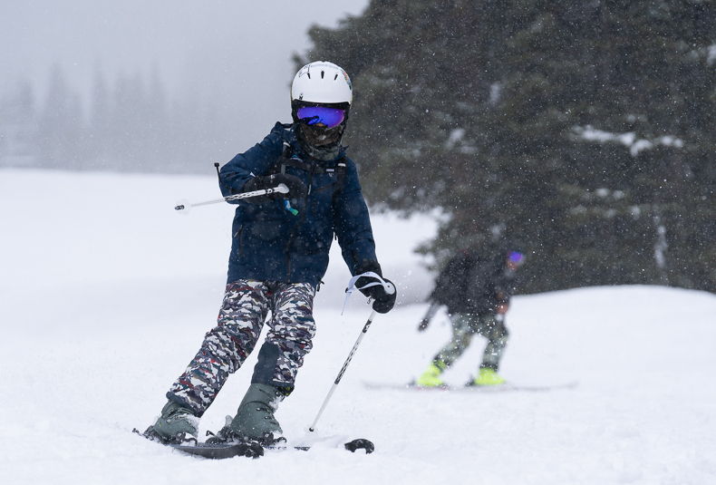 Skier is properly attired and bundled up for a chilly day on the slopes.