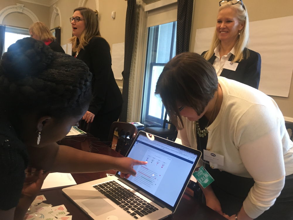 Turnitin's Stephanie Butler looks on while a student tries out Turnitin Revision Assistant at the White House Innovative Assessment Tech Jam on December 8.