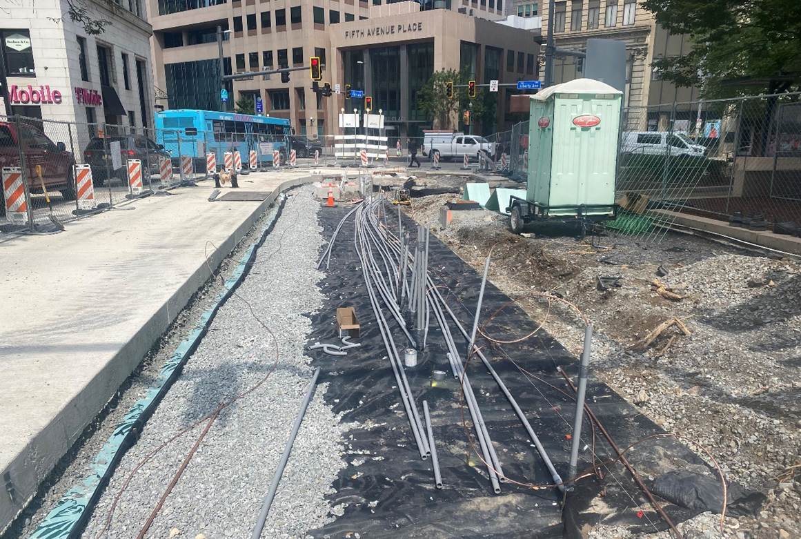 Inside the work zone at Fifth Avenue and Market Street, electrical crews pulled conduit that will supply power to the new bus station and transit amenities