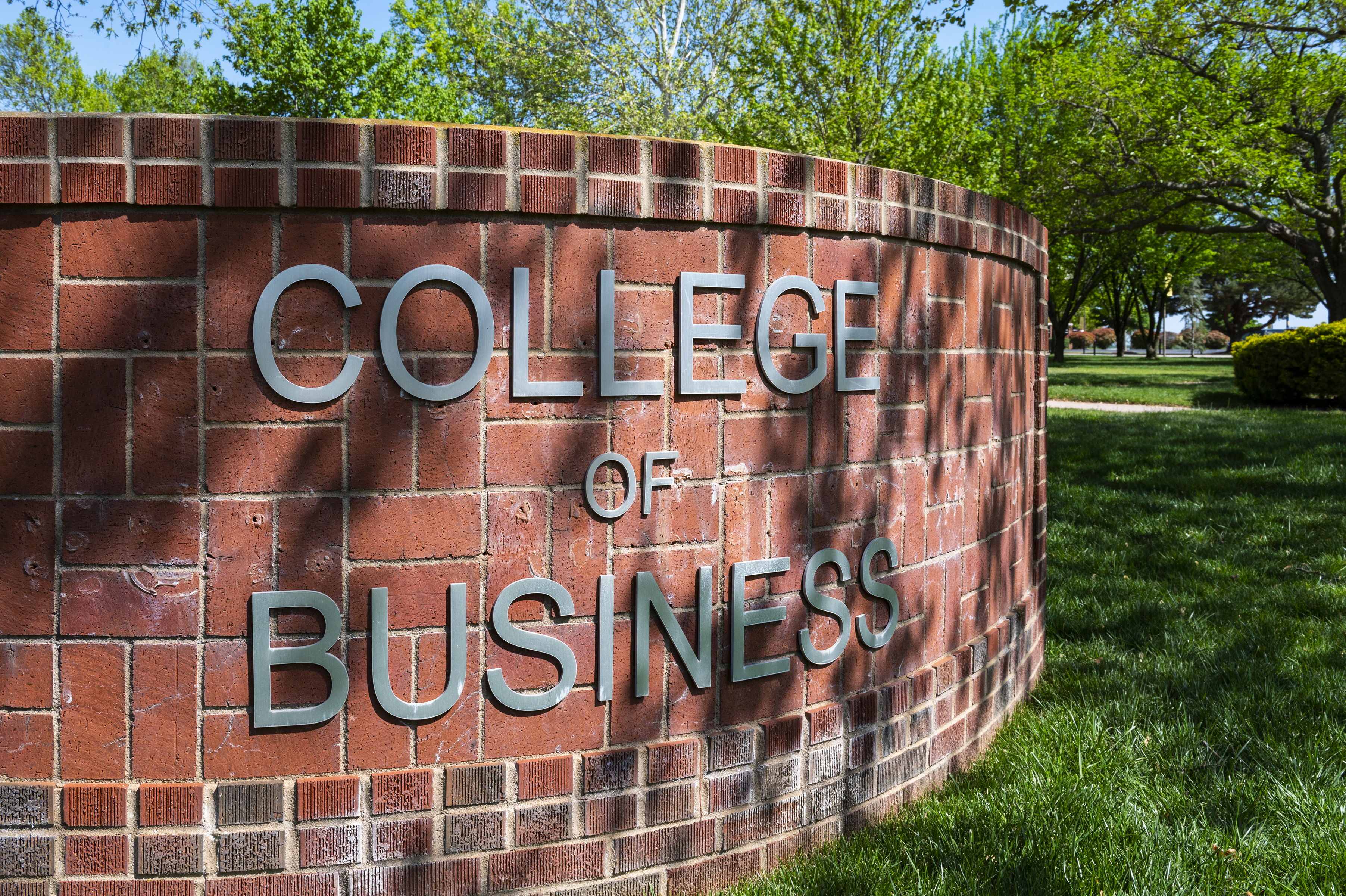 The UCO College of Business sign in front of the business building.