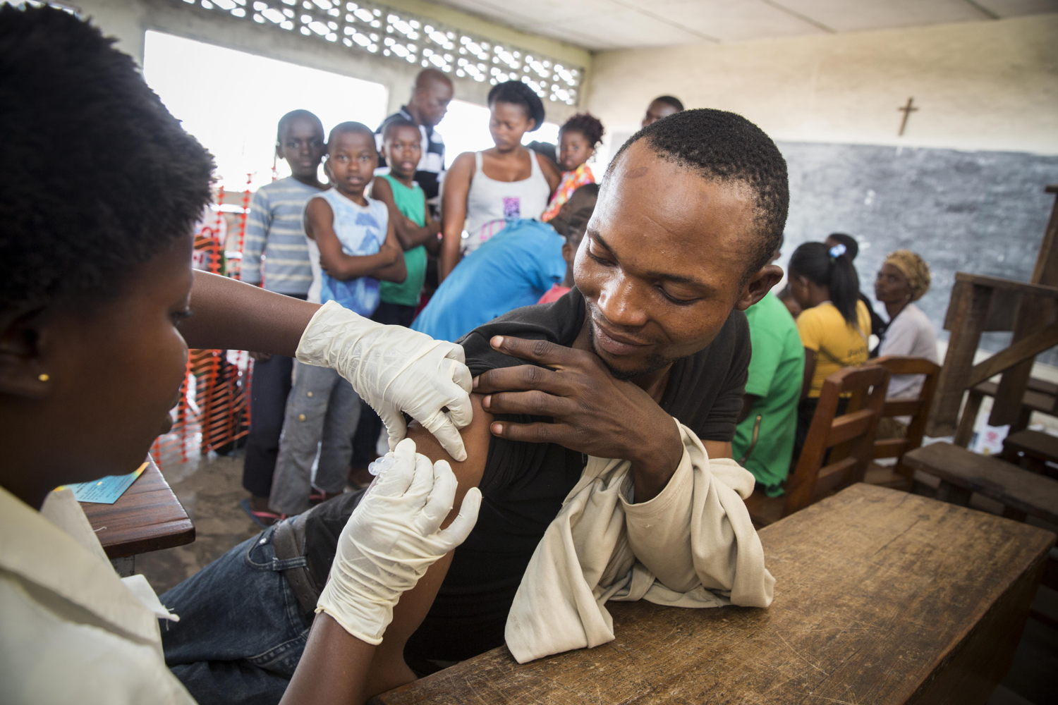 A young man receives a yellow fever vaccination in a school in the Zone de Santé Kikimi in Kinshasa, DRC. After an outbreak of yellow fever MSF organised a large vaccination programme. 178.2016, credit 
Dieter Telemans