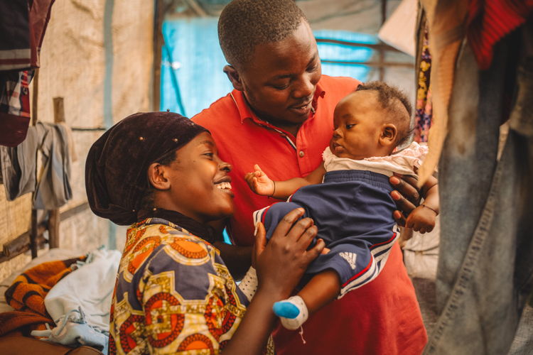 Copyright: Philémon Barbier Countries: Democratic Republic of Congo Date taken / Date Recorded: 04 January, 2024 Caption / Description: Francine, 24, and Jean-de-Dieu, 29, both from Kiwanja in Rutshuru territory, look after their 3-month-old son Amini Naël inside their tent in the Kanyaruchinya IDP site north of Goma, North Kivu, Democratic Republic of Congo, 4 January 2024.