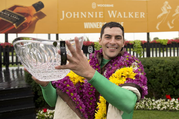 Sahin Civaci poses with the Woodbine Oaks trophy. (Michael Burns Photo)