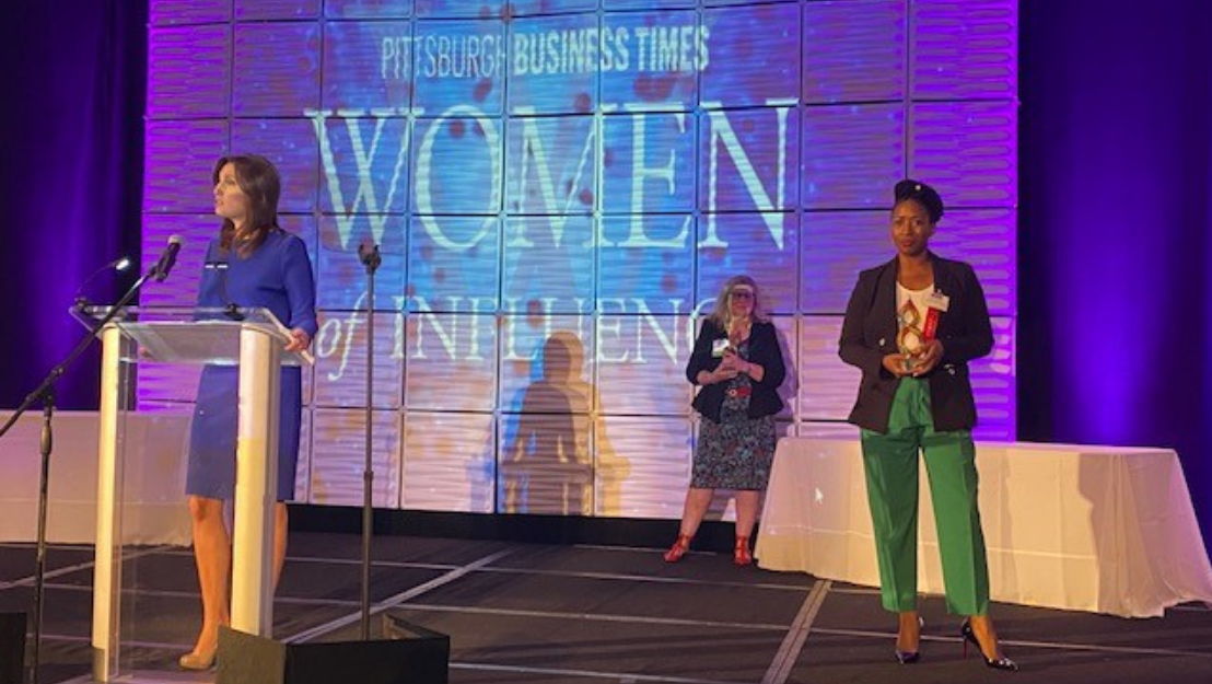 Tishekia Williams (right) receives her award as one of Pittsburgh Business Times&#x27; 2021 &quot;Women of Influence&quot; at the Westin Convention Center Hotel on Oct. 6, 2021.