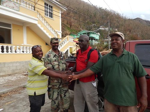 Solidarity in the face of hardship: Ambassador to the OECS H.E Dr. Patrick Antoine (centre) with residents and first responders in Dominica