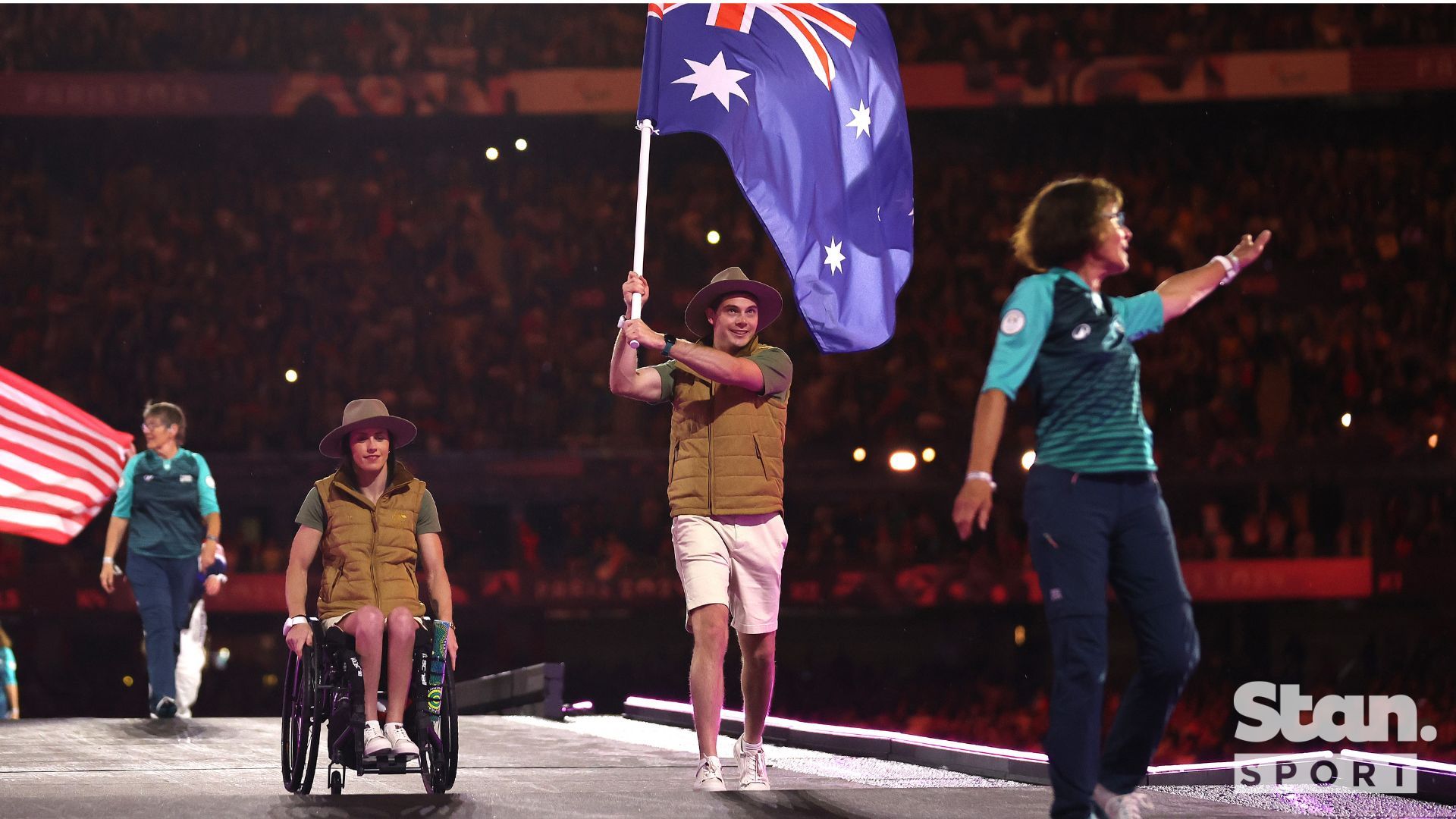 Dual Gold Medallists Lauren Parker and James Turner fly the Australian flag at the Closing Ceremony.