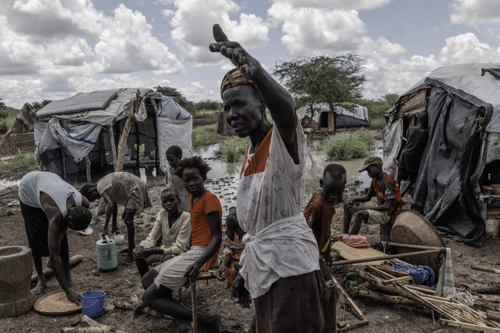 Nyanyath Achueng and her family are presently residing on a flooded roadside levee opposite a UN compound. 09 August, 2023. Copyright: Sean Sutton/Panos Pictures