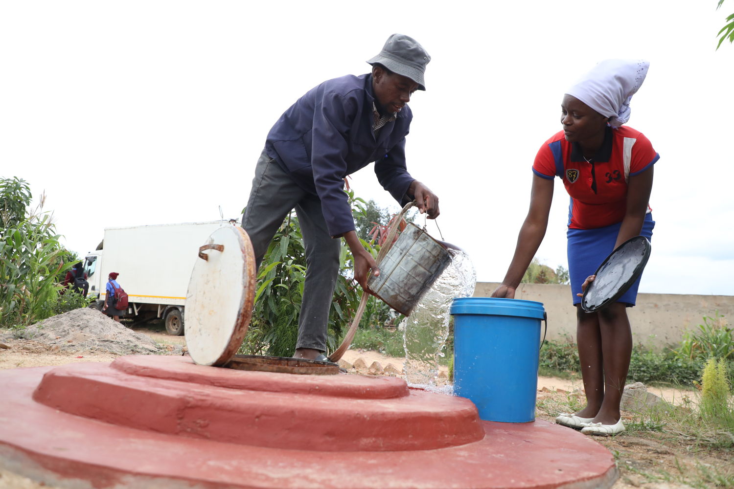 Precious Kapeka collects water from a well in Stoneridge. The community has benefitted from MSF installing boreholes and wastewater management system in Stoneridge to prevent bacterial contamination which used to occur as a result of underground septic tanks. Photographer: Dorothy Meck