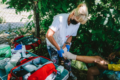 An MSF nurse straps up the ankle of a patient during a medical consultation of the MSF mobile clinic in Horgos 2 border crossing area in Serbia. In 2022 MSF is operational in informal settlements at the Serbian-Hungarian and Serbian-Romanian borders, with two mobile clinics providing primary health care, psychosocial support and health promotion activities, assessing and treating patients for physical... Copyright MSF