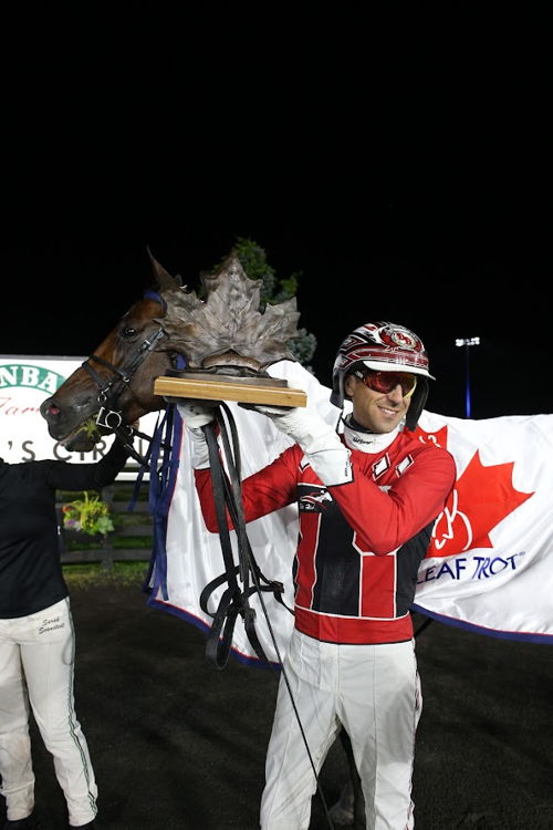 Alraja One IT and Dexter Dunn in the winner's circle for the Maple Leaf Trot on September 2, 2023 at Woodbine Mohawk Park (New Image Media)