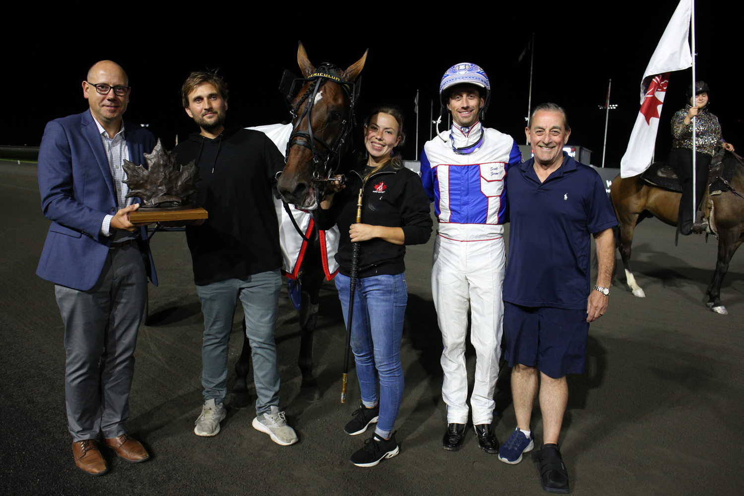 Periculum and connectiones in the winner's circle for the Maple Leaf Trot on August 31, 2024 at Woodbine Mohawk Park (New Image Media)