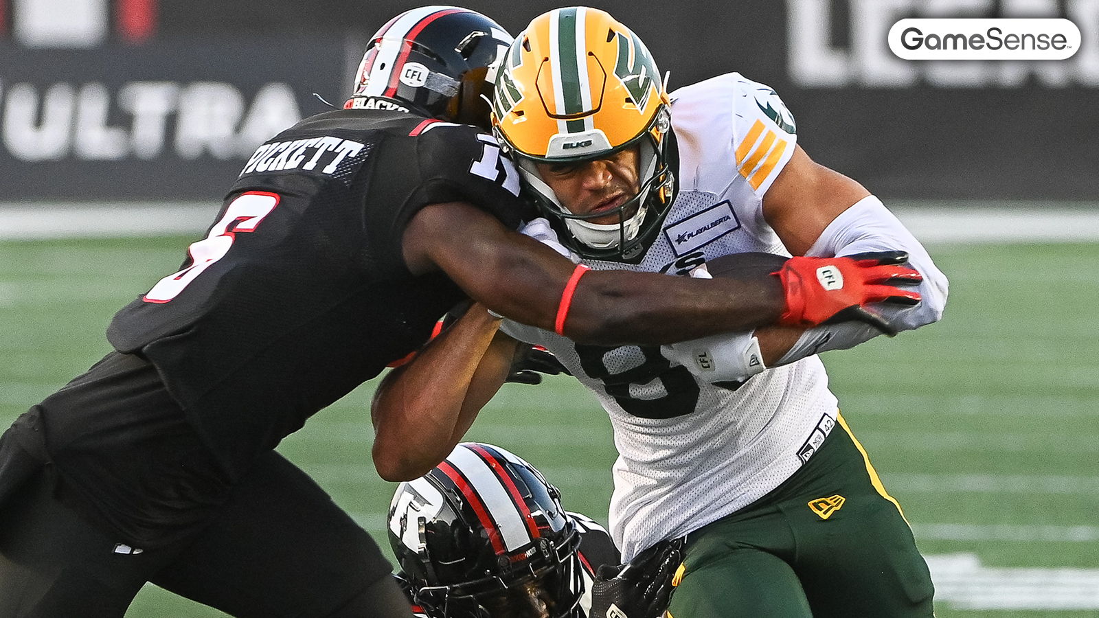 Arkell Smith fights through a tackle by Ottawa's Adarius Pickett