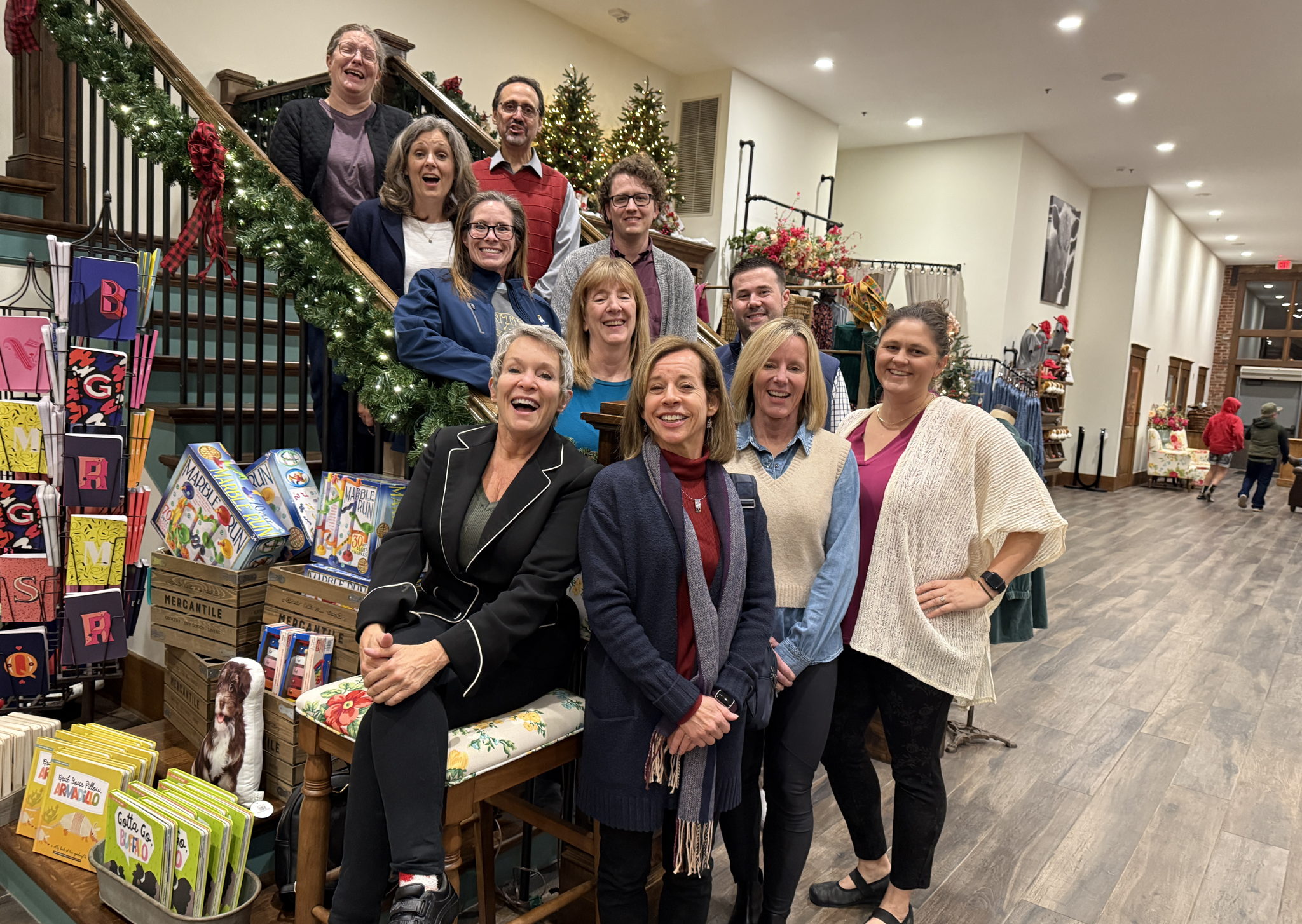 A group of individuals posing on a staircase during a holiday event.