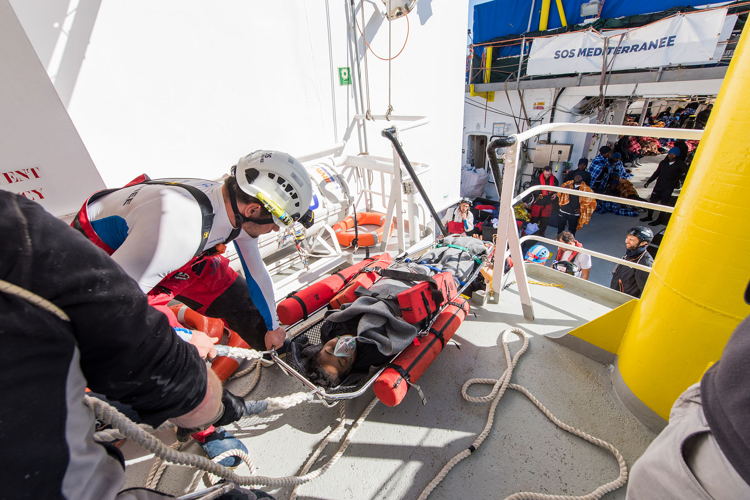 A woman with water in her lungs is medically evacuated from Aquarius after a critical rescue on 27 January 2018. Copyright: Laurin Schmid/SOS MEDITERRANEE