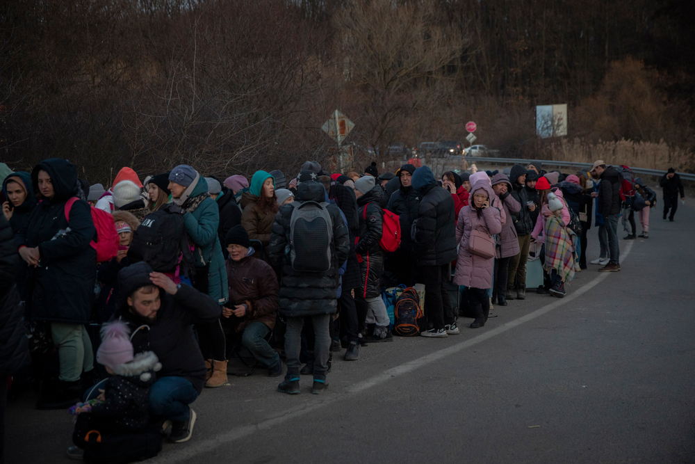 Hundreds of people wait in line to cross the border on foot into Slovakia from the city of Uzhhorod in Ukraine's Transcarpathia region, March 6, 2022. Photographer: Santi Palacios / MSF