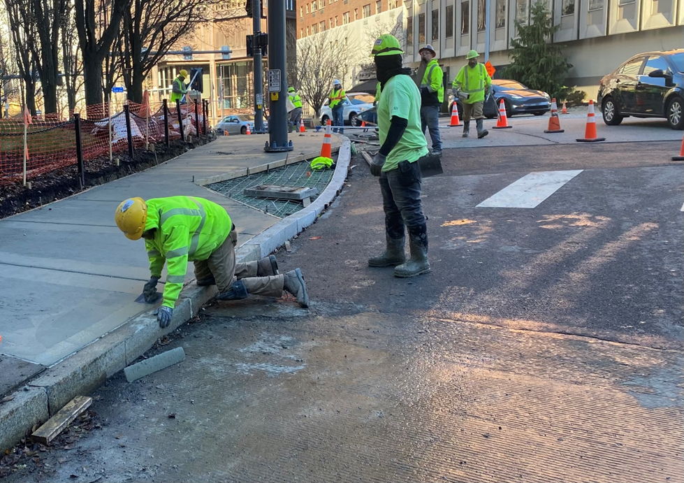 PRTs contractor finishing sidewalk restoration at Sixth and Centre avenues