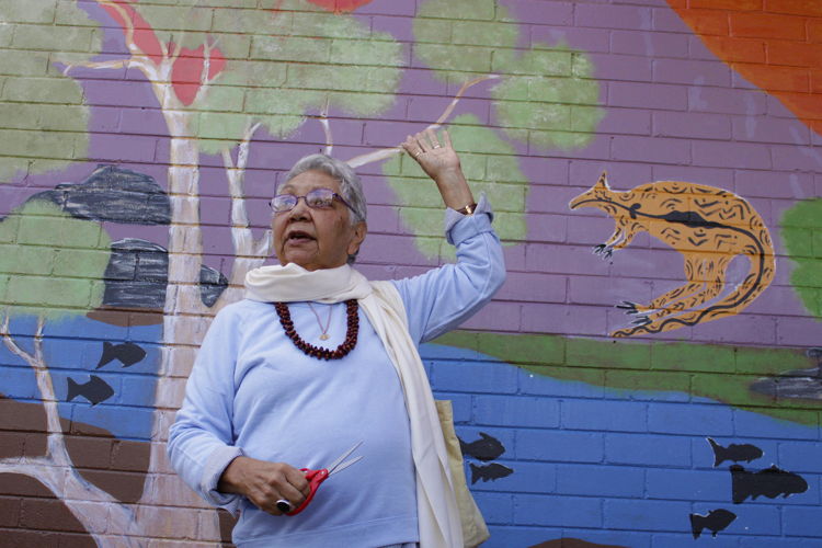 Dr Matilda House in front of one of the murals in Canberra. Image: Adam Spence: ANU.
